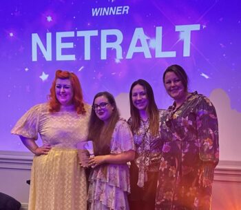 2307-NETRALT-TPAS-award photo of NETRALT collecting award from Michelle McManus