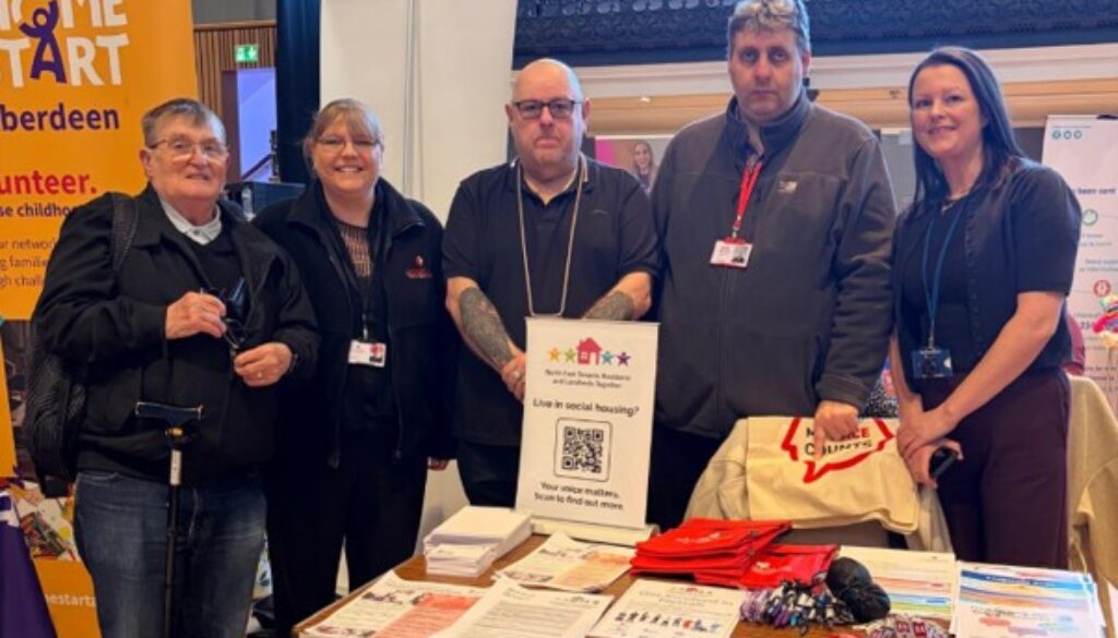 NETRALT members standing at their stall at Empower event